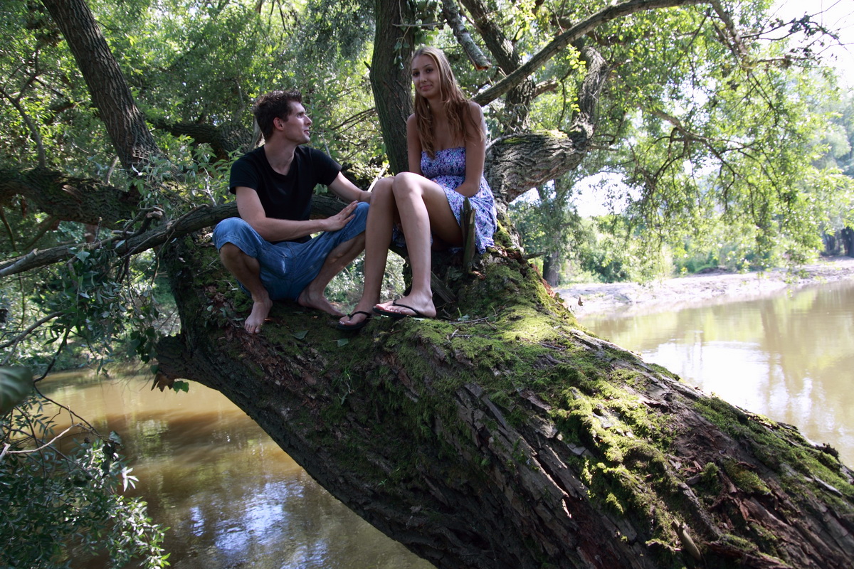 Young girl and her boyfriend have sex on a tree limb over the water -  NakedPics