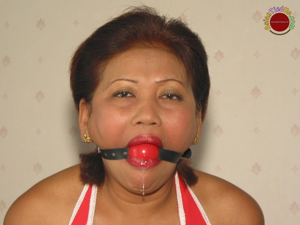 Mature Asian Woman Drools After Being Fitted With A Ball Gag While