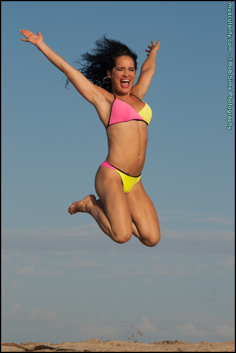 Bodybuilder Leila Denio Poses In Bikinis During Solo Action At A Beach