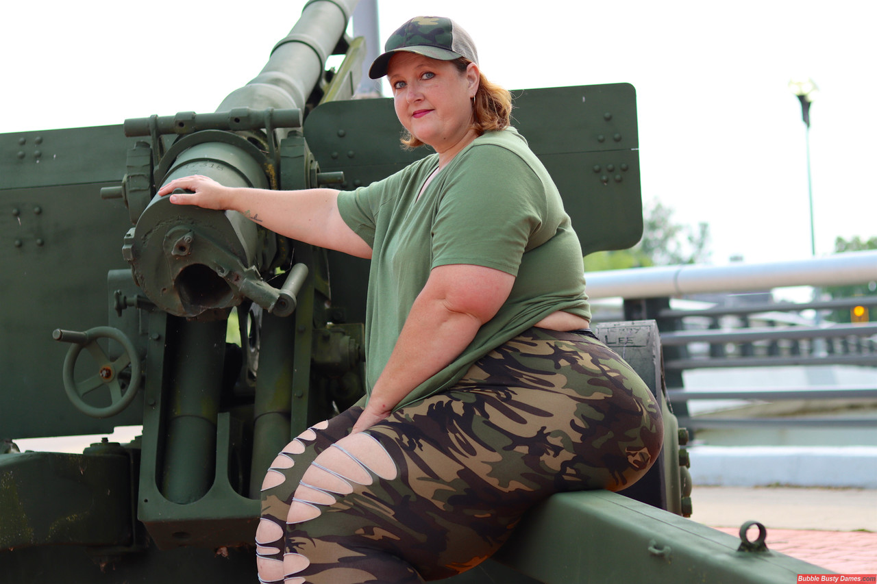 Obese amateur Goddess Pear models for a SFW shoot on an artillery gun in  camo - NakedPics