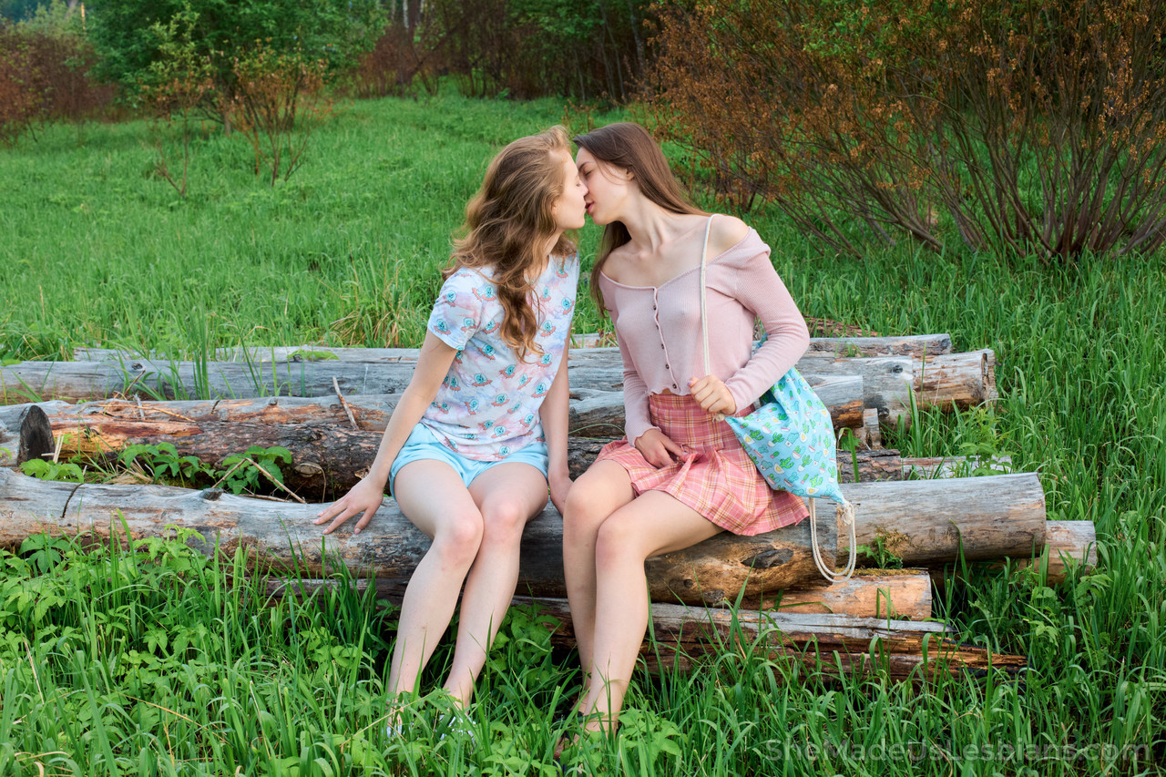 Young girls have lesbian sex on a blanket in a lush field near the water -  NakedPics