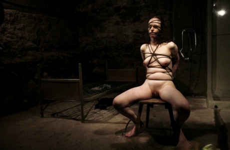 縛られたブルネットのNadjaは、軍人に電気器具で拷問される。