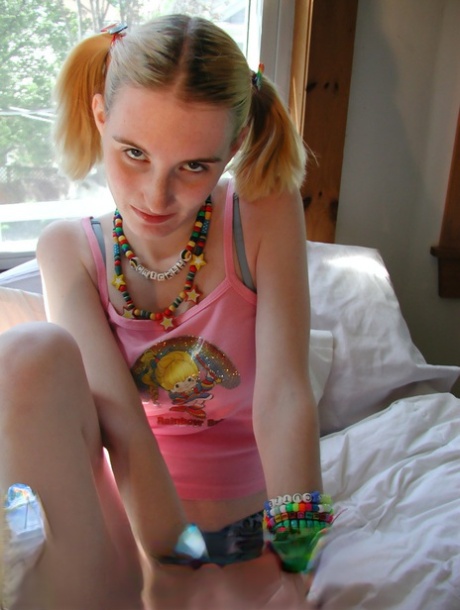 Young looking raver girl Cricket wears bangles while getting naked on her bed