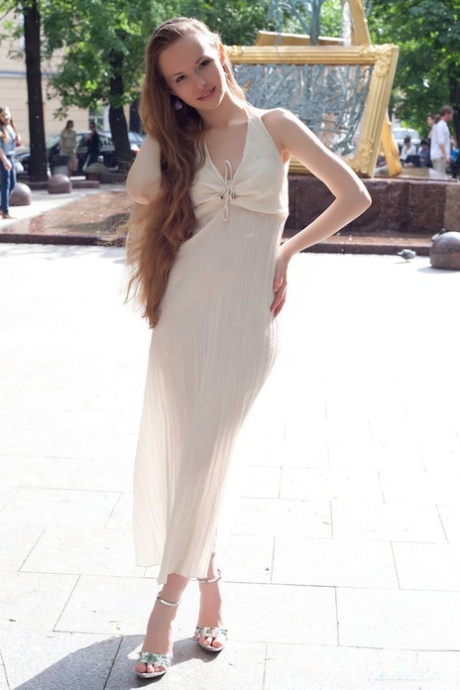 Charming teen with really long hair Virginia Sun frees her goods from a dress