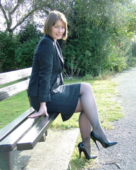 Pretty non nude woman in black stockings flaunting her heeled feet outdoors