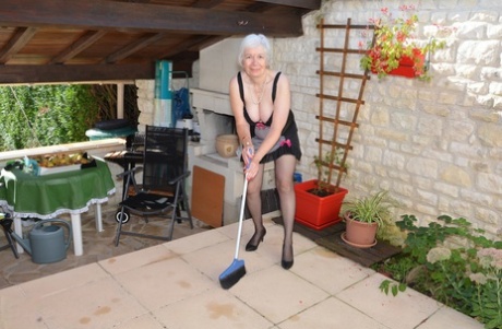 Похотливая бабуля приподнимает сексуальную юбку, чтобы поиграть со своим бобром в саду