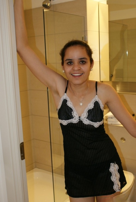 Knap Indiaas meisje gaat topless op een toiletbril zitten
