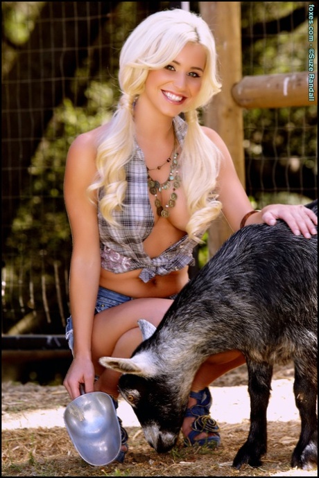 Platinum blonde babe Spencer Scott feeds goats before getting naked in heels