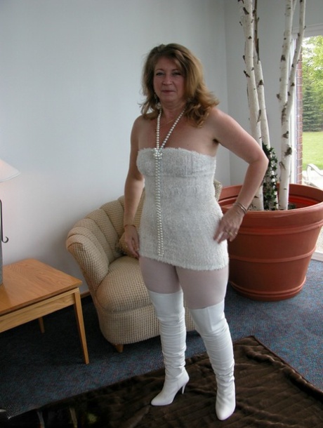 Mature fatty shows off her snatch in crotchless hose and over the knee boots