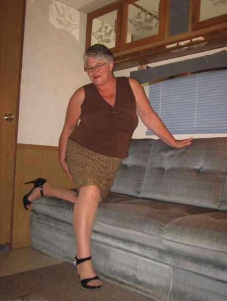 Fat granny Girdle Goddess gets naked on a sofa in stockings and footwear