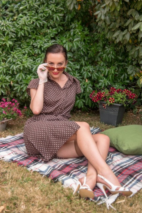 Older model Sophia Smith posing outdoors topless in vintage panties & garter