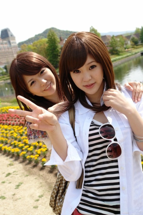 Japanese lesbians Rimu Endo & Ueno Misaki show bare legs while taking a stroll