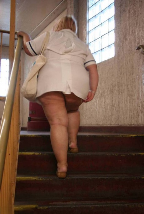 Fat older nurse Lexie Cummings exposes herself while walking on a sidewalk