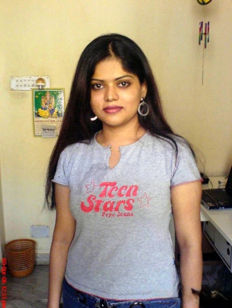 Petite Indian girl uncups big naturals after removing blue jeans