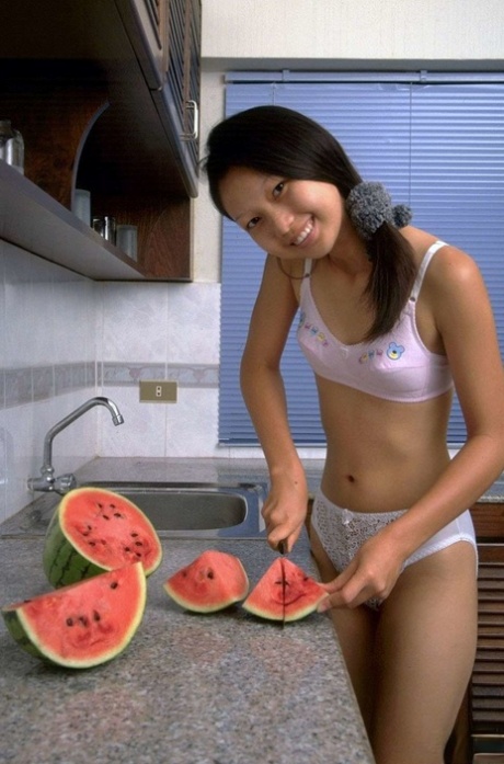 Charming Asian teen removes lace underwear while eating a watermelon
