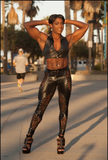 Ebony bodybuilder Jaquita Person Taylor flexes while walking her dogs