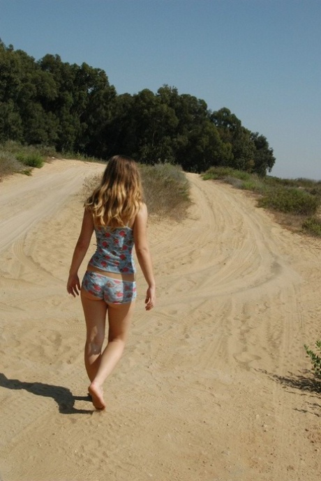 Sweet young girl exposes her butt crack while alone on a dirt road