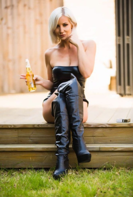 Hot blonde Jennifer Jade smokes and drinks in over the knee leather boots