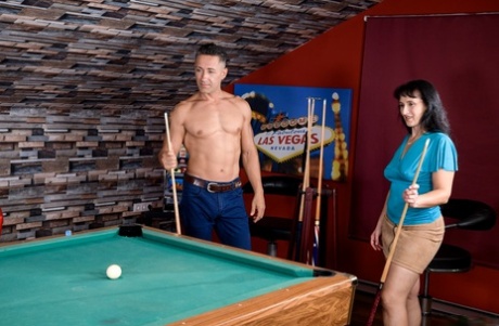 Dark haired woman and her man friend shoot pool before fucking on the table
