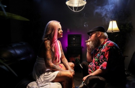 Tattooed blonde Evilyn Ink tattoos a bearded man before masturbating
