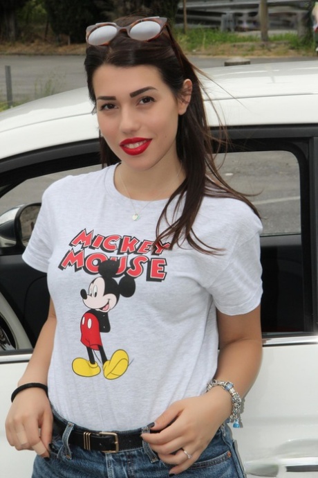 Sexy dívka ukazuje své sexy nohy v autě, zatímco má na sobě tričko s Mickey Mousem