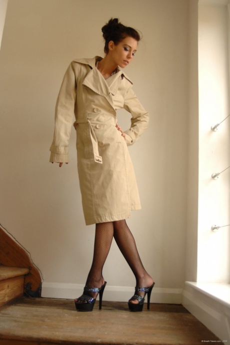 Glamour model Rosie releases her skinny body from a trenchcoat in stockings