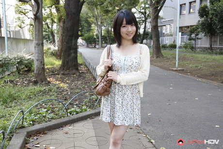 Japanese girl Madoka Adachi shows her bare legs during non-nude outdoor action