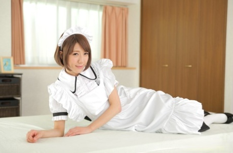 Japanese maid Erina Takigawa goes nude on a bed in white knee socks and heels