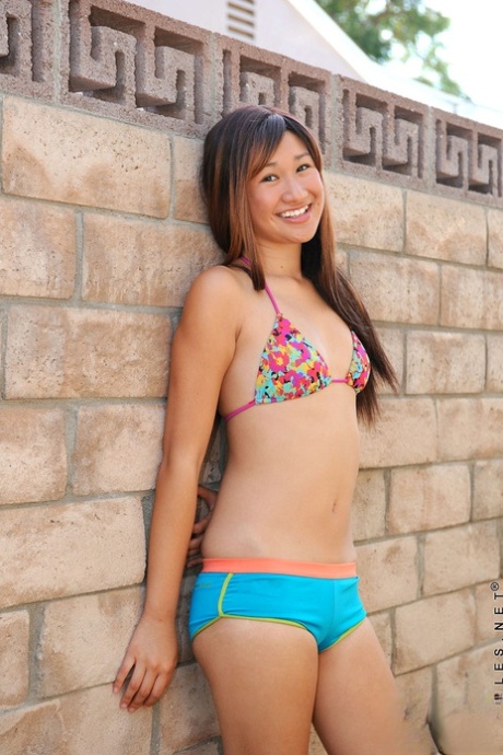Cute Asian teen removes her bikini to reveal tiny titties & spread poolside