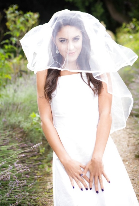 Carolina abril, uma rapariga latina, fotografada ao ar livre com o seu vestido de noiva