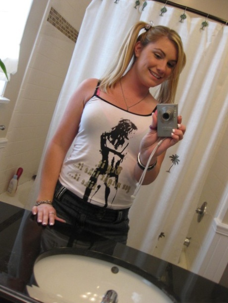Blonde gf Hayden Night snaps selfies in bathroom while licking a lollipop