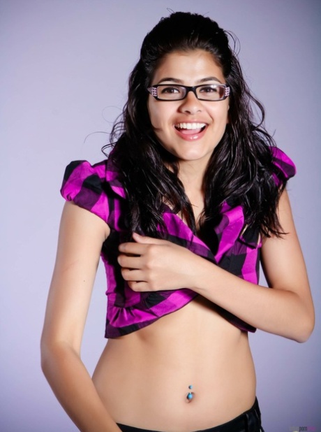 Nerdy Indian girl covers her naked breasts with her hands in a thong