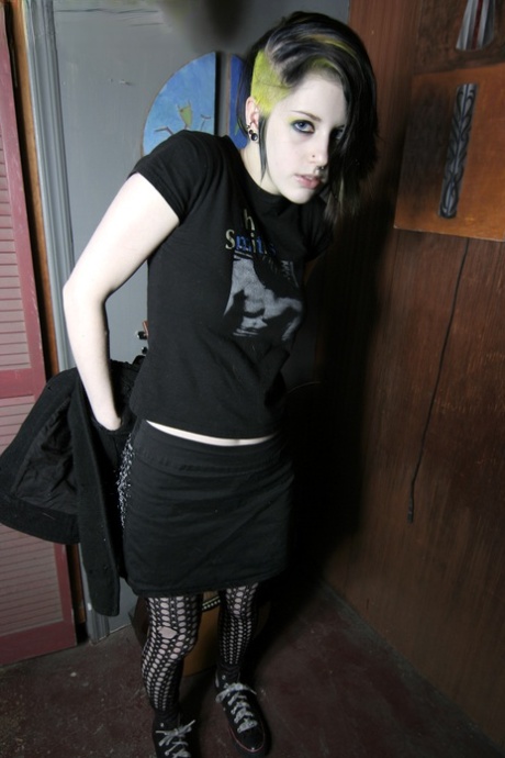 Goth misfit Rubella loses her clothes to display her soft body and perky tits