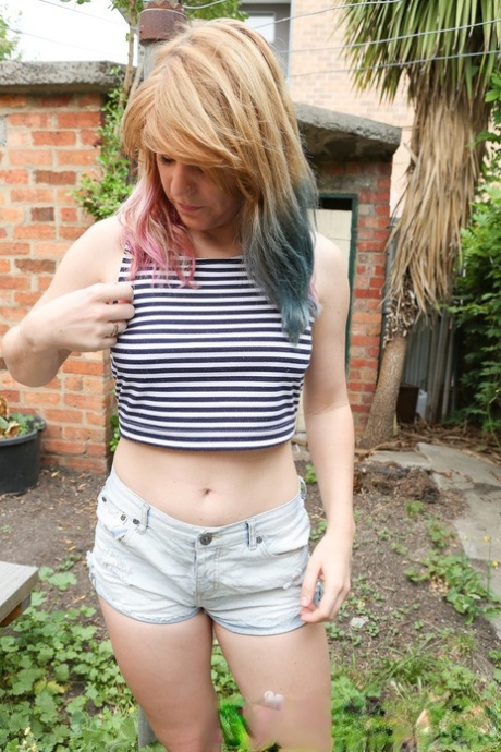 Solo girl with multi colored hair Ophelia Rose expose her clit in the garden