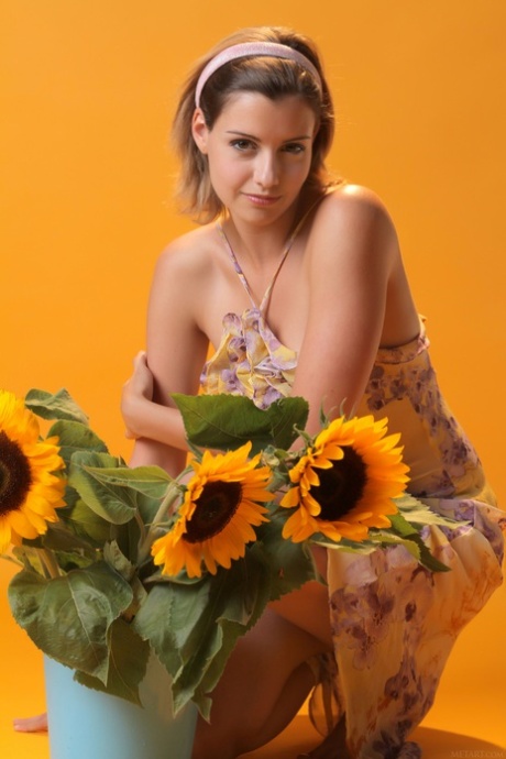 Sexy teen beauty Vienna flaunts her big tits and poses with sunflowers
