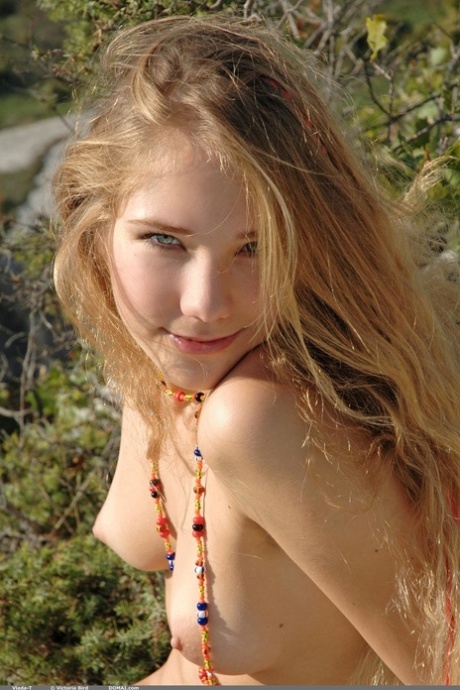 Glamorous blonde Vlada T posing butt naked on the rocky mountain