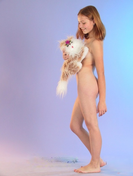 Cute redheaded teen Ola strips down naked and poses with her stuffed animal