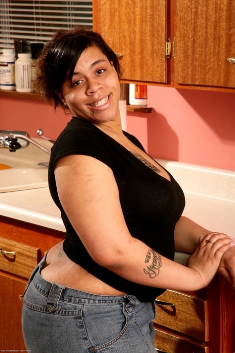 Hairy ebony Nykole shows off her big tits & her great ass in the kitchen