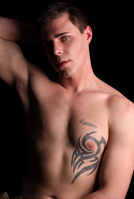 Horny gay boy Joshua Cohen unveils his inked chest and rubs his penis