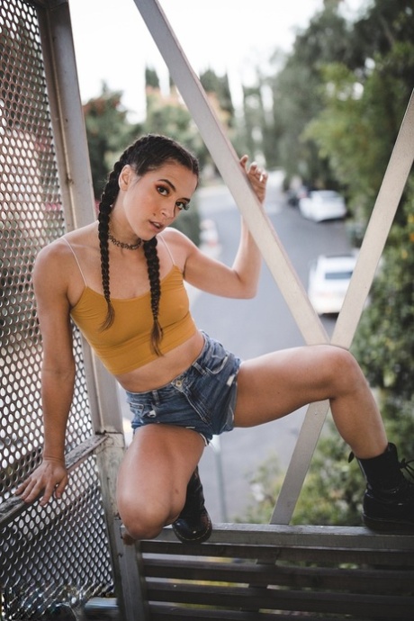 Brunette pornstar Abbie Maley poses hotly in shorts & a bodysuit & gives head
