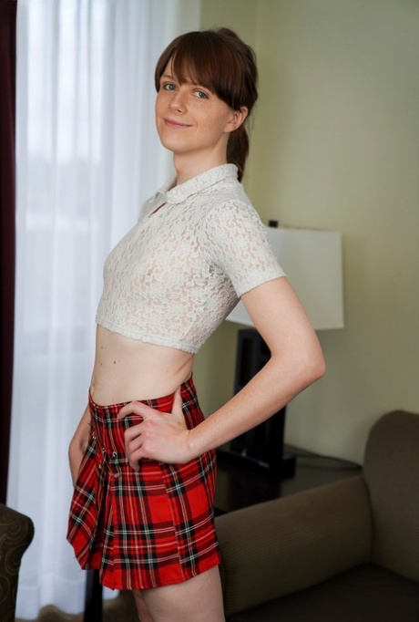Skinny shemale Alice Kollars doffs her plaid skirt and flaunts her asshole