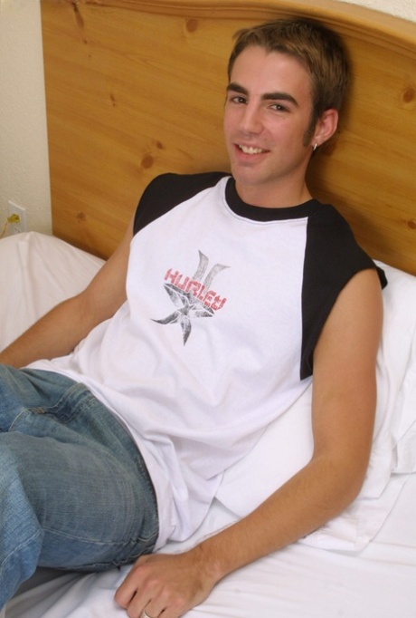 Cute gay with earrings Kirk strips and fondles his big dick on a bed