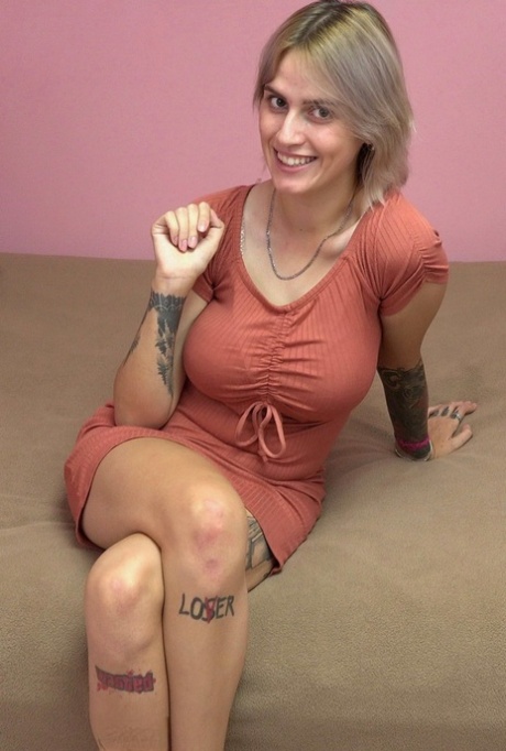 Charming blonde Tina Ray shows her sexy inked body and toys herself