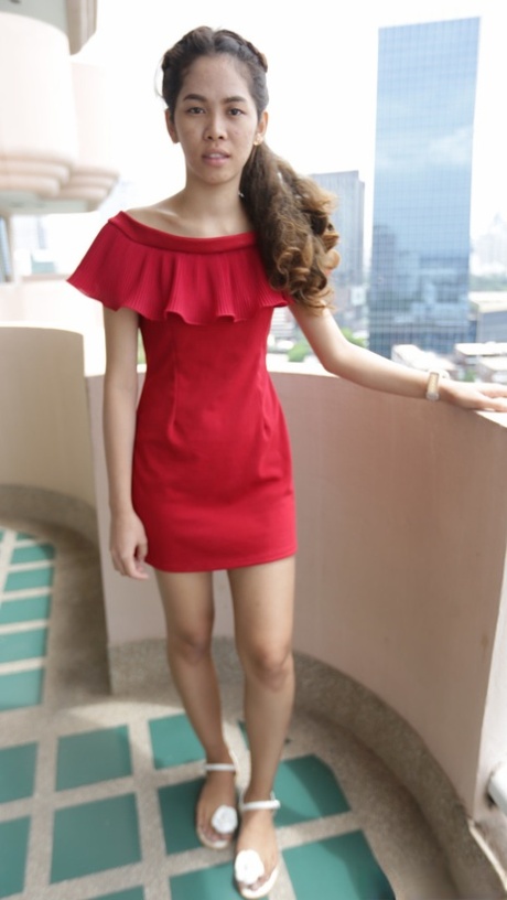 Beautiful Asian girl Mee shows off her hot legs in a short red dress