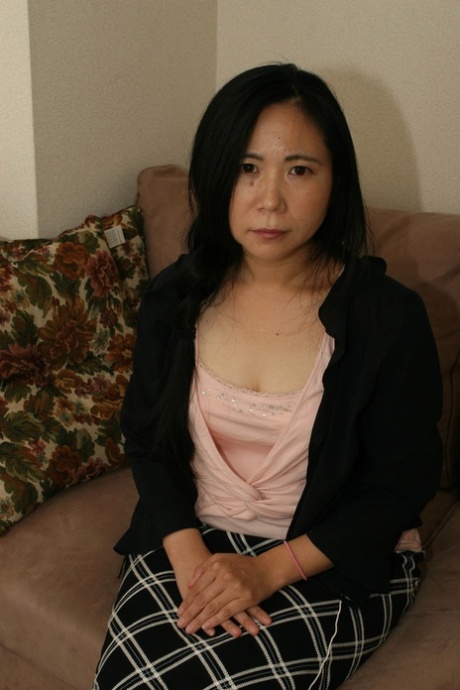 Cute Japanese granny Yasuko Watanabe strips and masturbates on the sofa