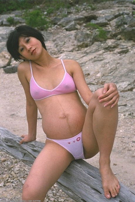 Pregnant Japanese teen Miho strips in nature and shows her super hairy pussy